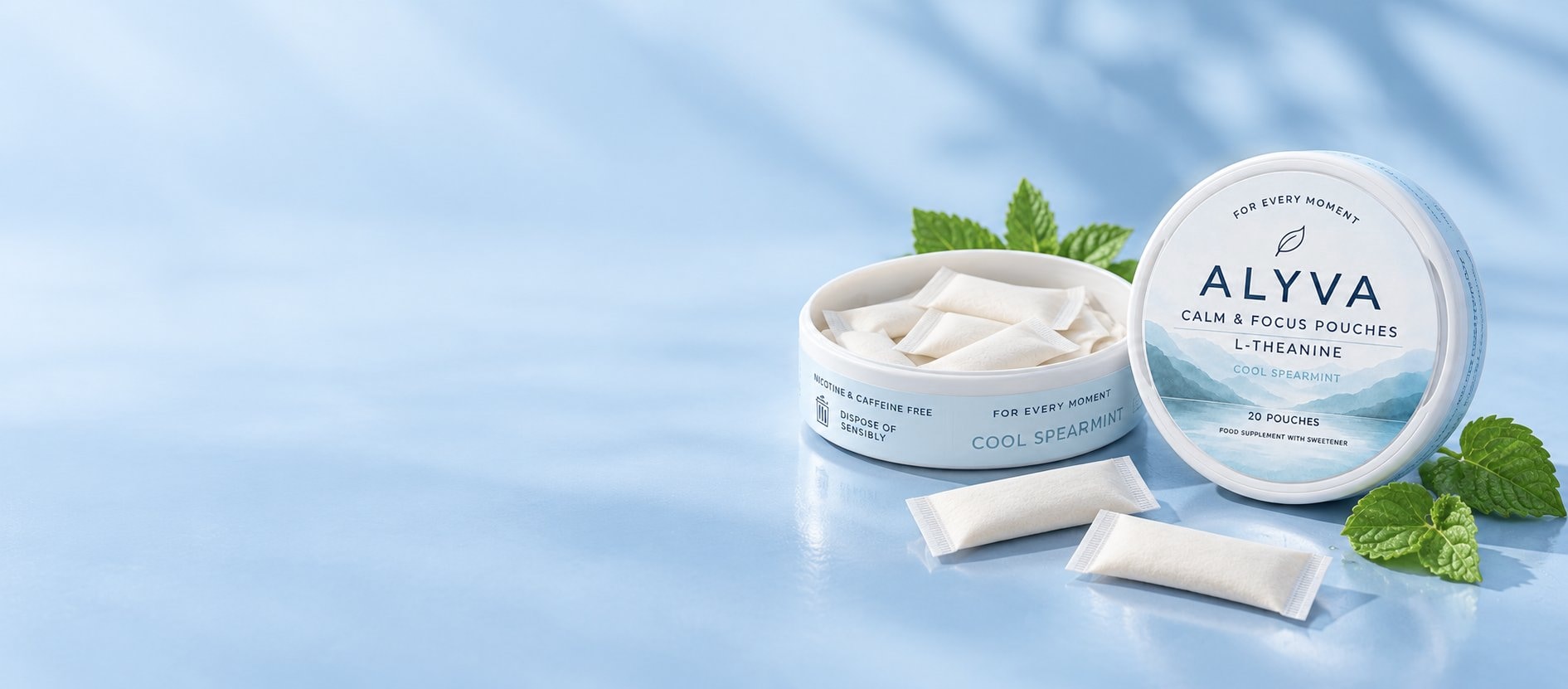 ALYVA Cool Spearmint L-Theanine pouch tins with fresh spearmint on a pale blue background